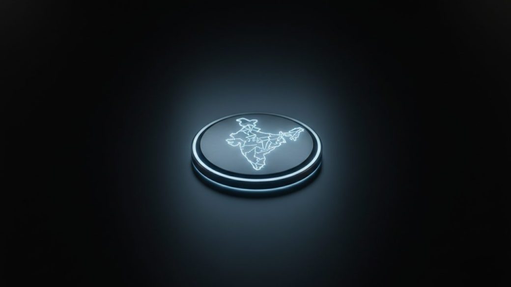 A single glowing microchip stamped with a small map of India, resting on a dark surface under dramatic high-contrast lighting, clean uncluttered background, no text