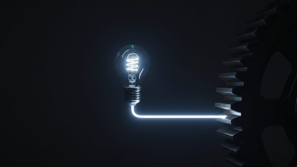 A single small glowing prototype lightbulb connected by a clean bright line to a larger factory-scale gear, dark uncluttered background, dramatic side lighting, high contrast, photorealistic