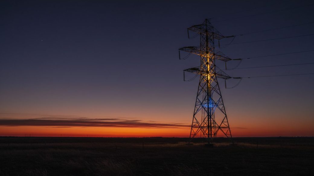 A lone electricity transmission tower glowing against a deep dusk sky, dramatic high-contrast lighting, clean uncluttered background