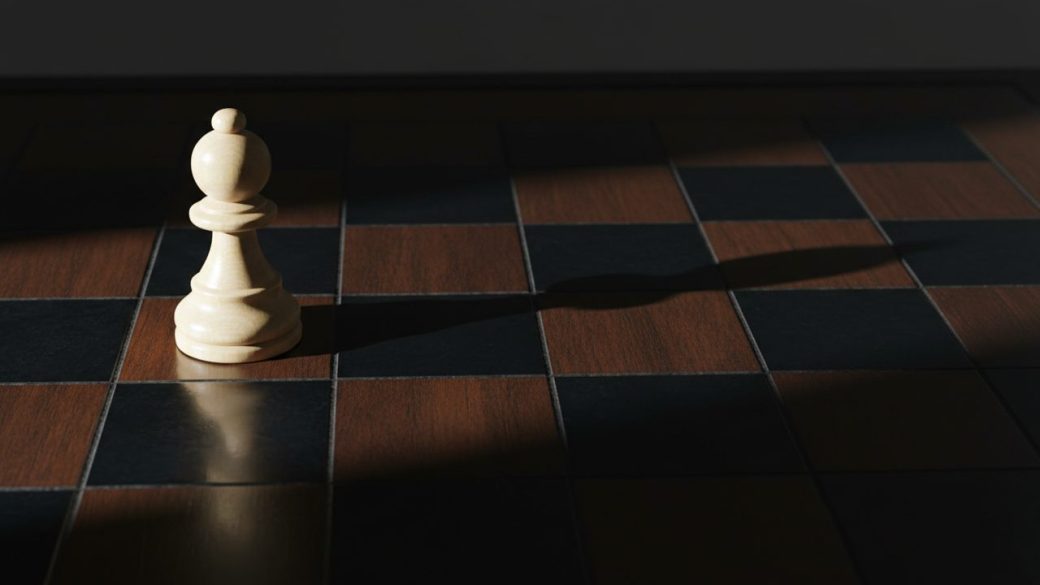 A single chess pawn casting a long shadow shaped like a king on a dark board, dramatic side lighting, high contrast, clean uncluttered background, no text
